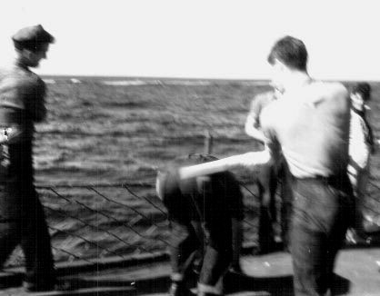 J. Ouwelant getting his butt whacked; 25DEC1943.