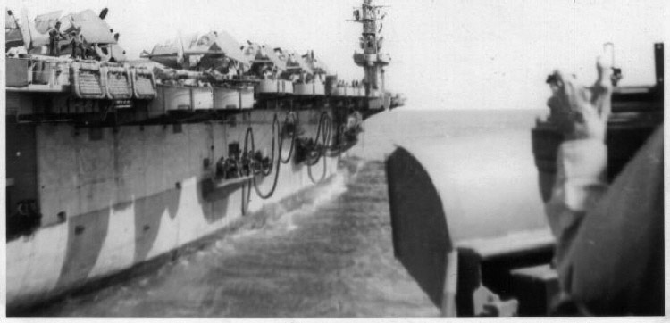 Alongside a carrier.